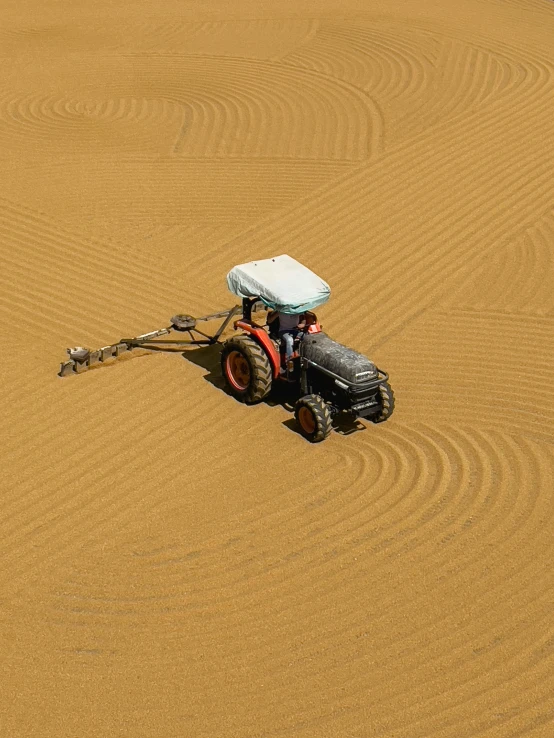 a tractor sits in the middle of a flat area