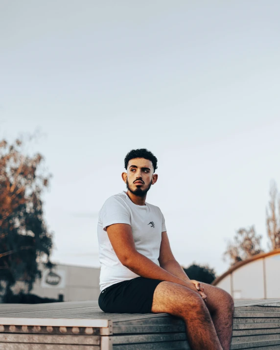 a man sitting on a stone bench outside