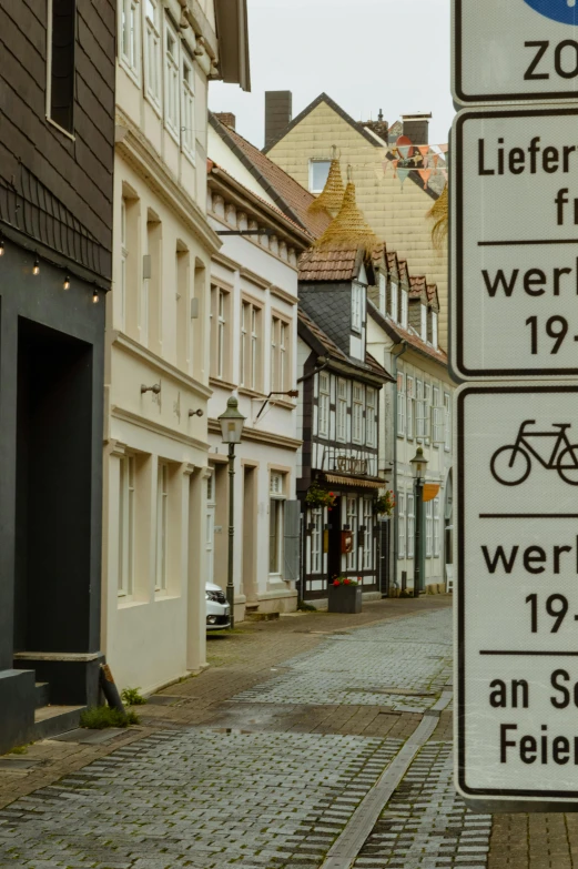 several signs sit outside in front of buildings