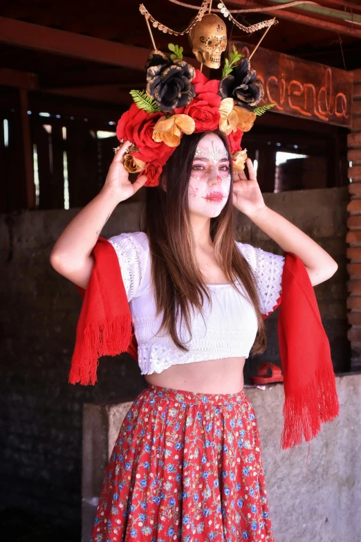 a beautiful young woman wearing a floral head dress