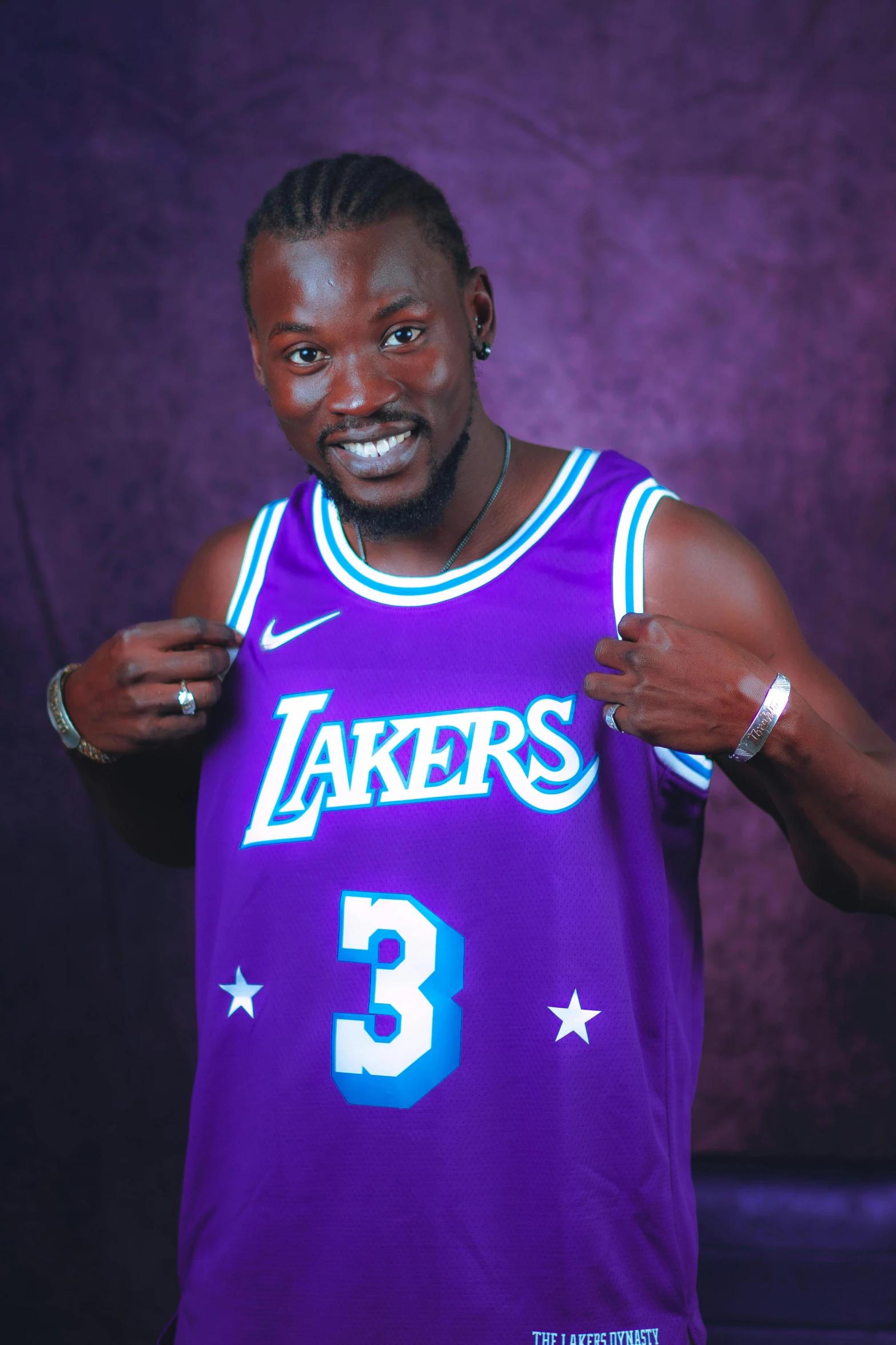 man dressed as the los angeles lakers posing for the camera
