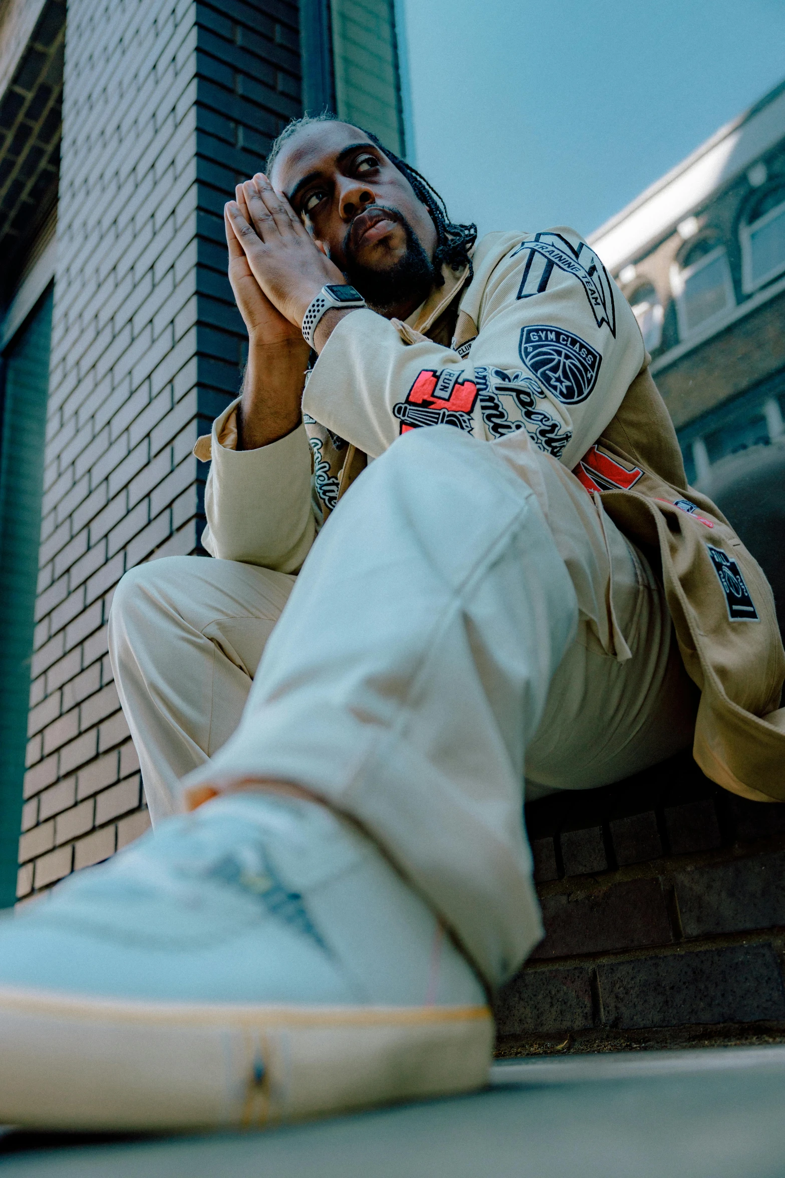 a man sitting on top of a brick floor