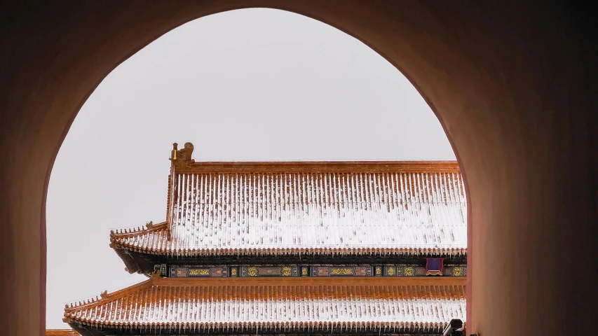 the archway to a building has a white roof