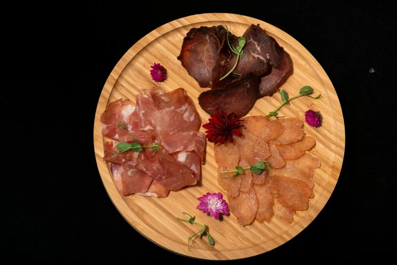 meat and other food items arranged on wooden plates