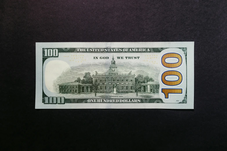a one hundred dollar bill is depicted on the surface