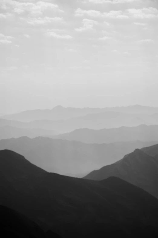 a black and white po shows hazy hills