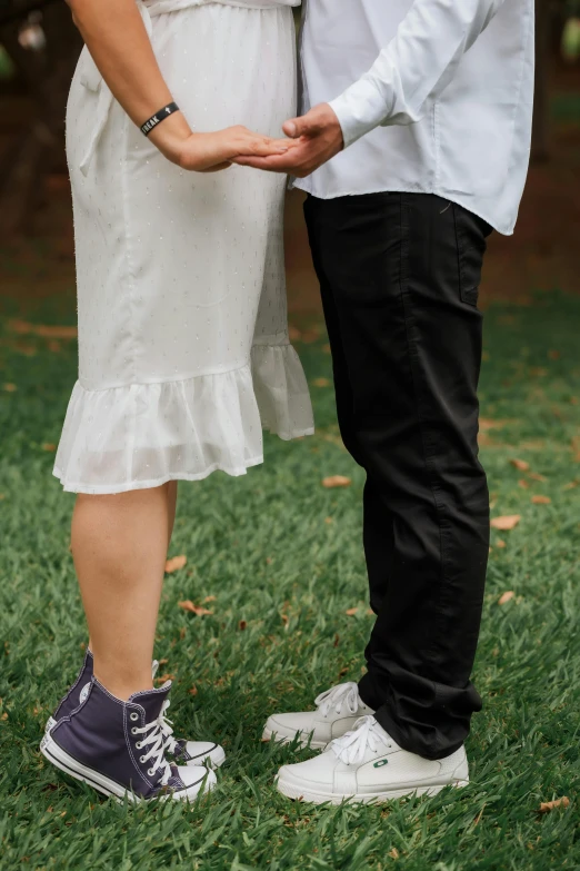 a close up of the legs of a young couple