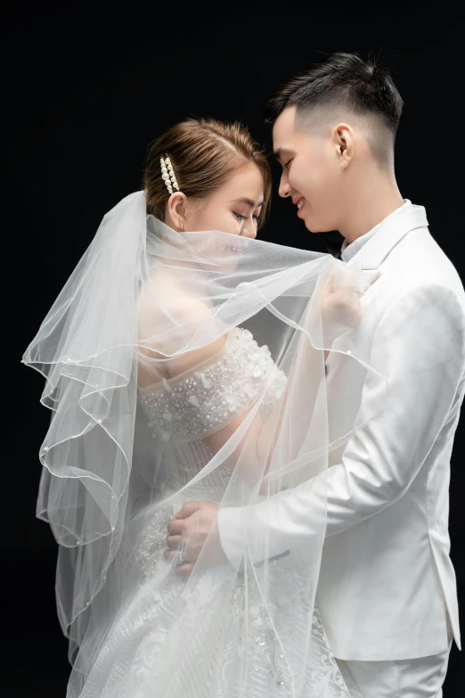 a man and woman are posing in front of a black background