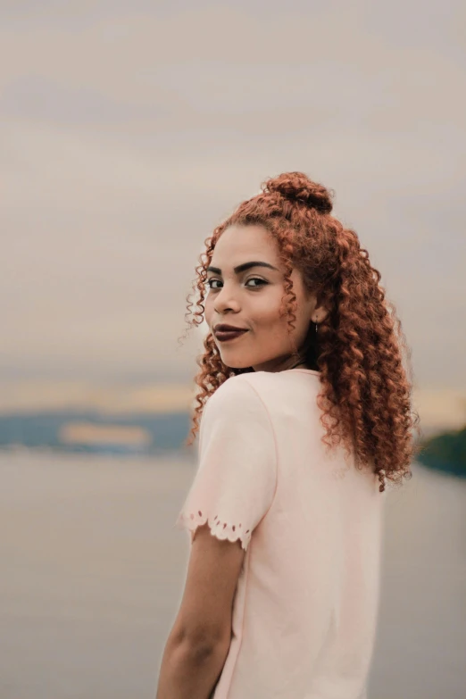 a woman standing outside and wearing freckled clothing