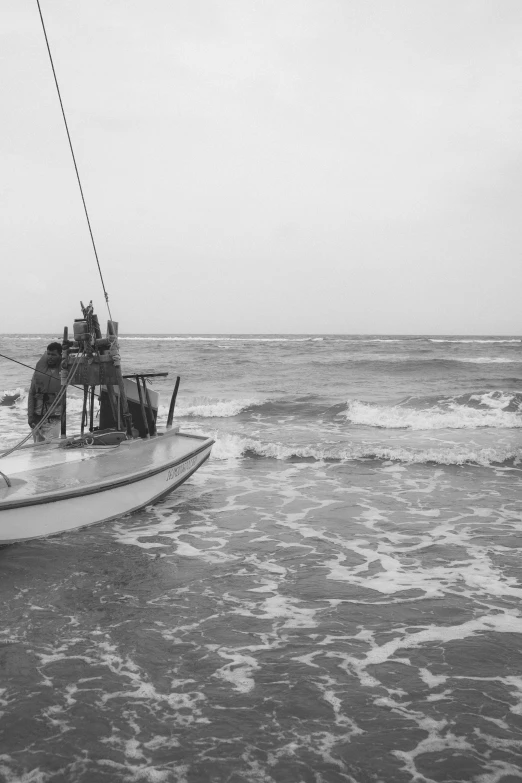 black and white image of a boat on the beach