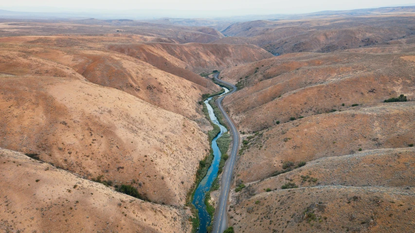 there is a river flowing in between the hills