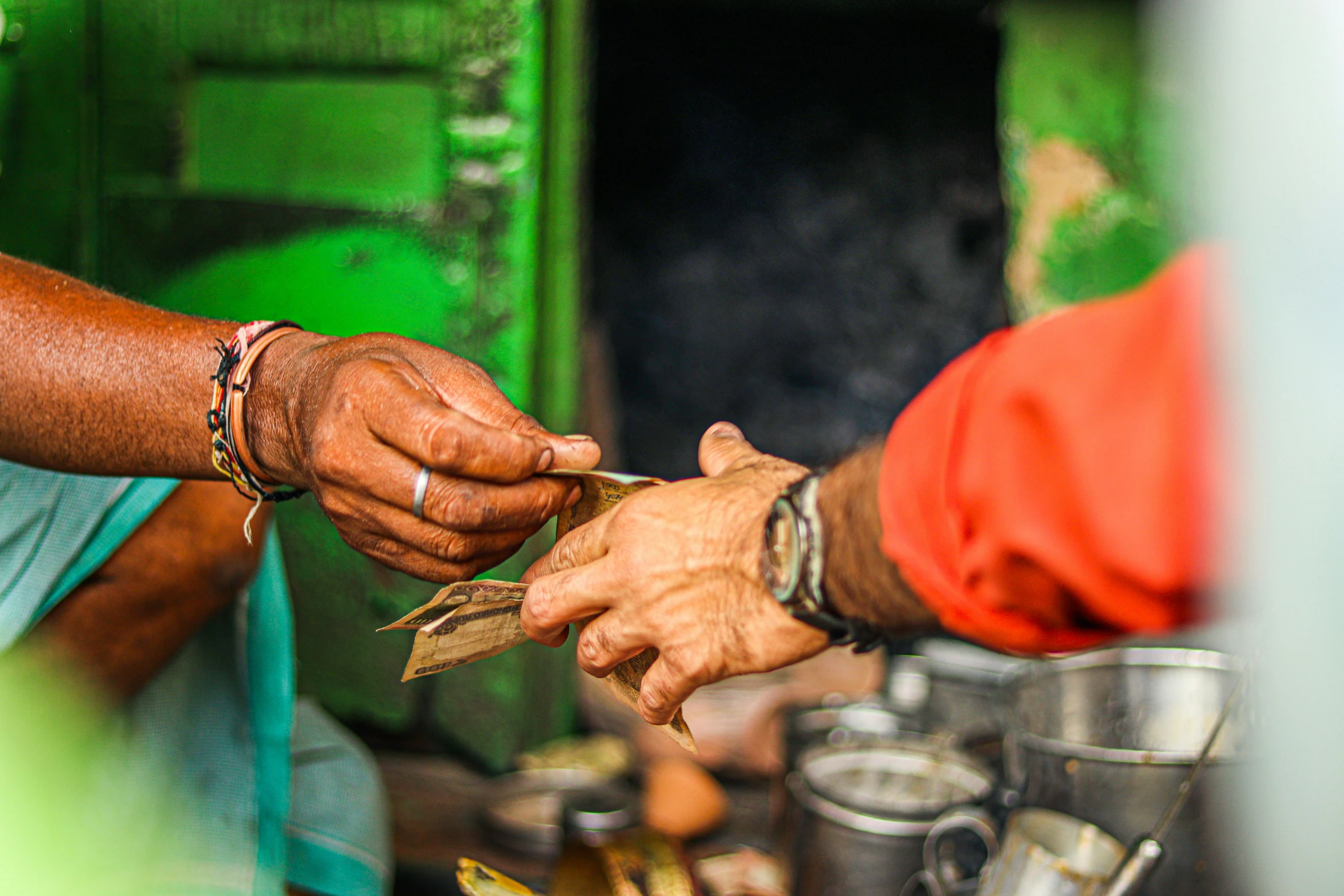 two people are holding cash in each hand