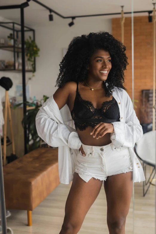 a beautiful young lady in lingerie standing in a room