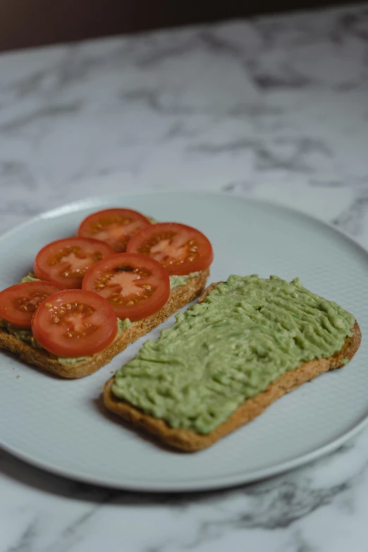 a white plate topped with toasted bread and veggies