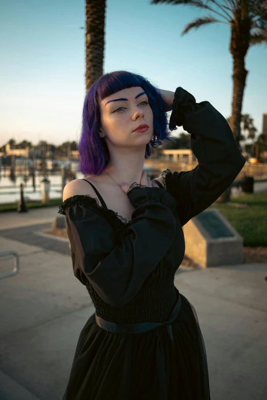 a person with blue hair poses for a pograph