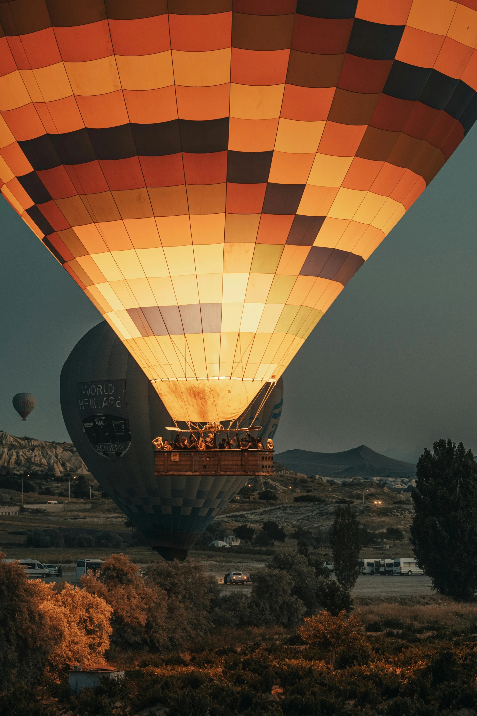 a large  air balloon flying above a landscape