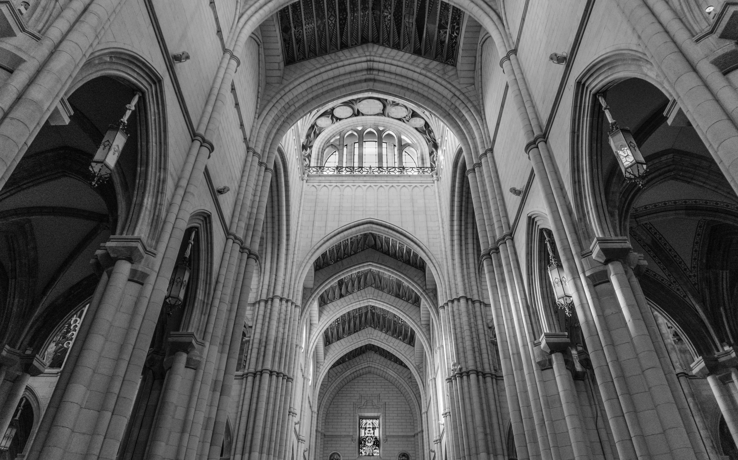 people inside of the cathedral, a church that has columns