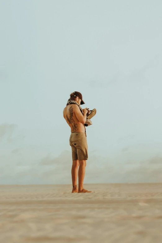 man taking picture with camera in the desert