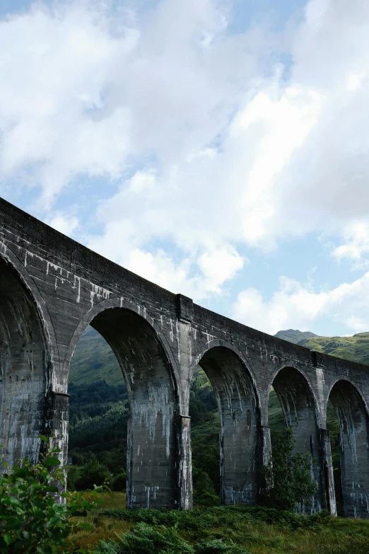 a picture of an old bridge in the countryside