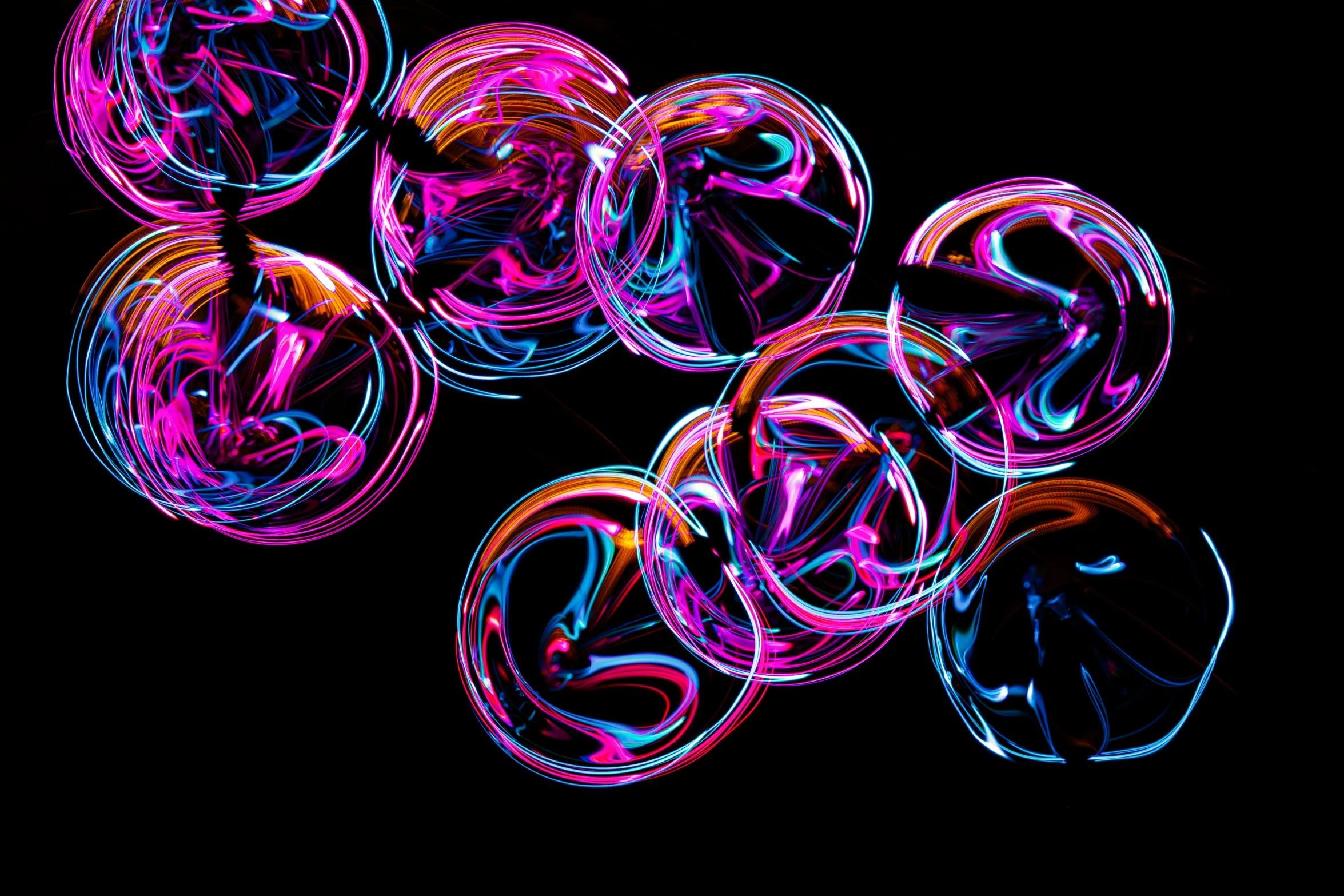 many circles and bubbles are illuminated in the dark