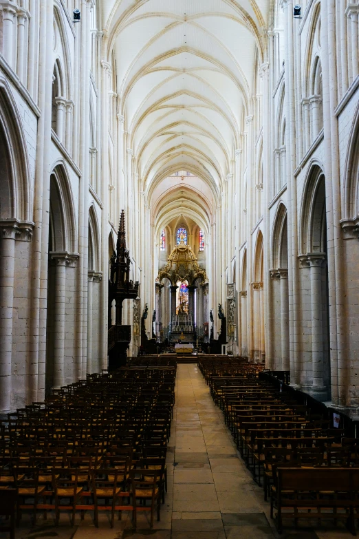 the navel of the interior of a cathedral with many pews