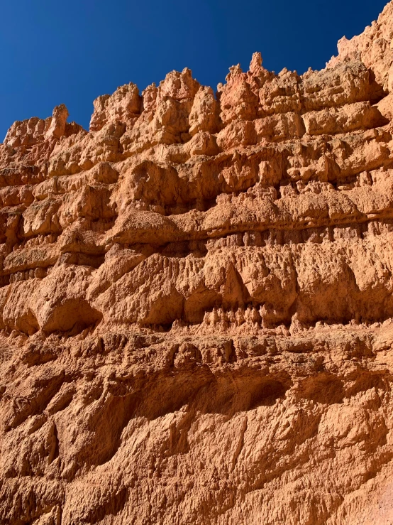 a very tall rock formation next to a mountain