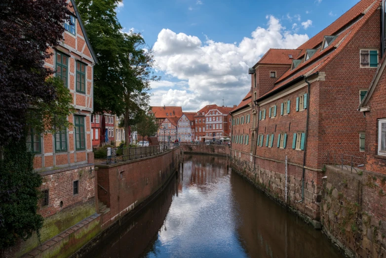 several brick buildings on the side of a canal