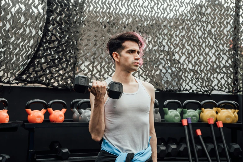 a man carrying some dumbs and preparing for a bodybuilding workout