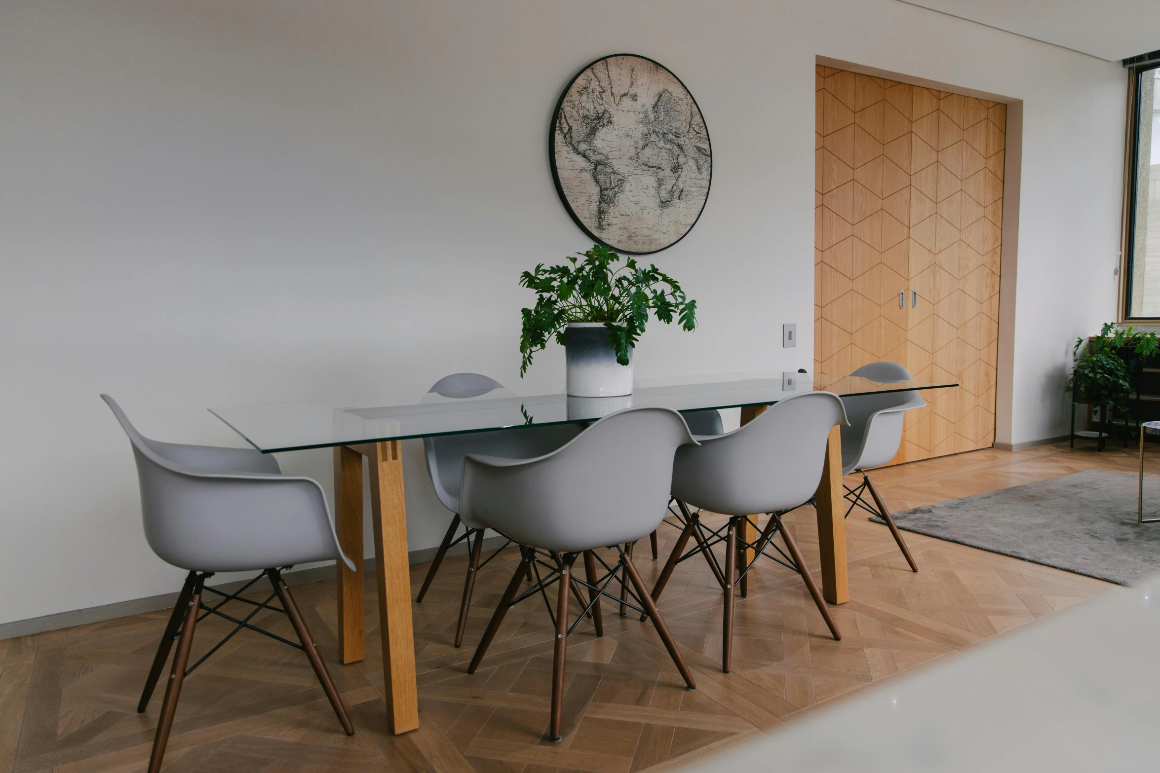 a table with a plant and some chairs on it