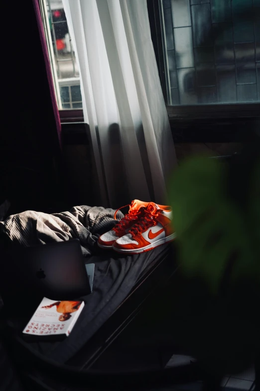 a black couch and a computer desk near a window