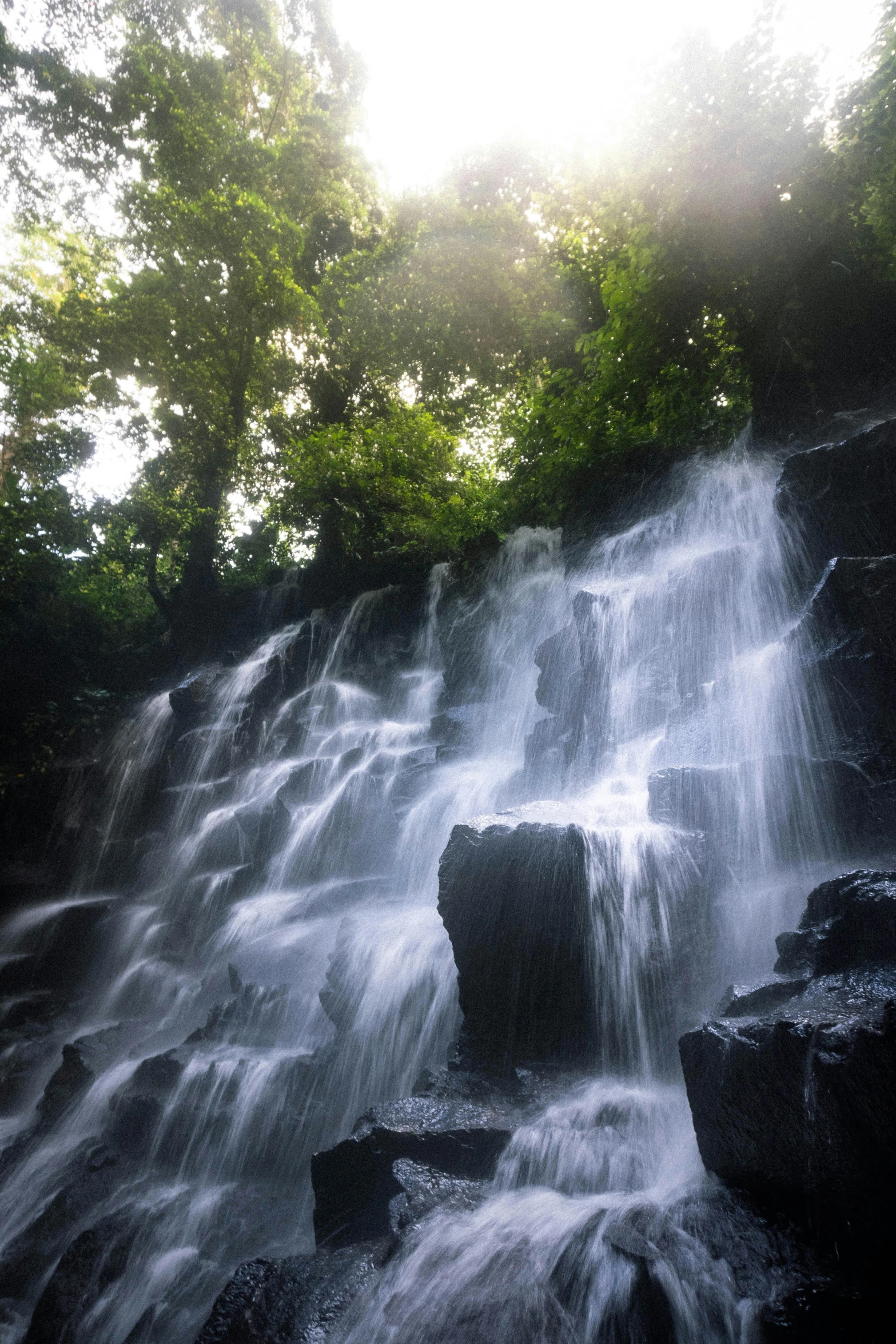 a very big waterfall that is running over some rocks