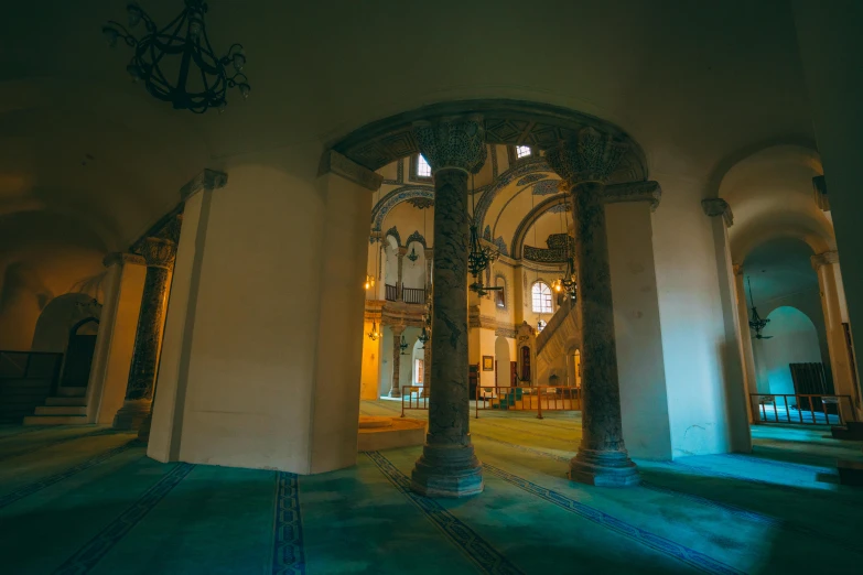 light streams through the arched doors into an empty church