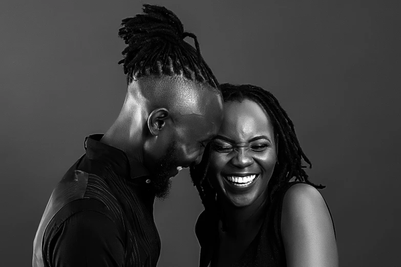 a man and woman smiling at each other