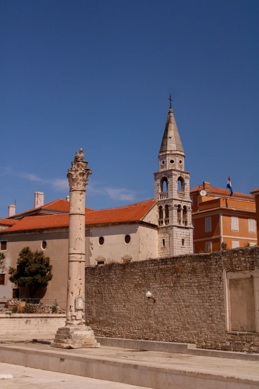 an old stone building with a tower near a street