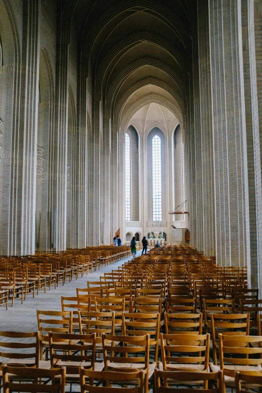 several wooden chairs lined up in a large room