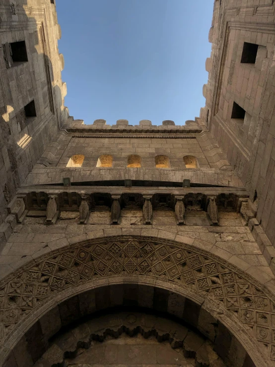 a building with an arch, doorway and light