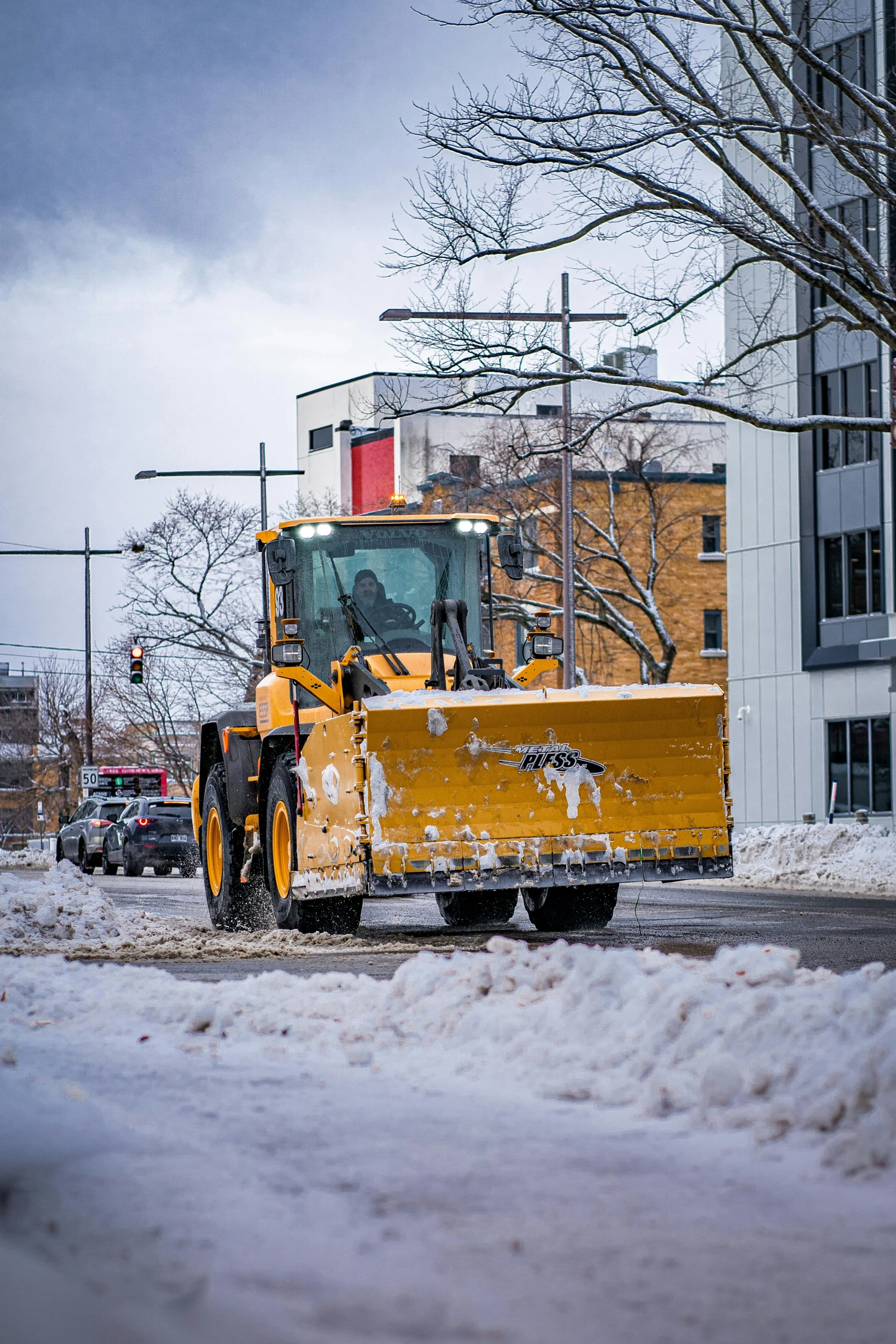 a street sweeper sweeping snow off in the city