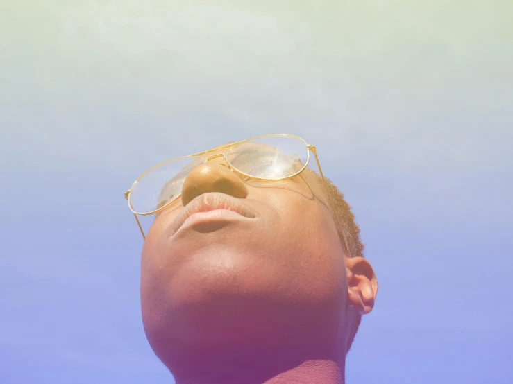 a close up of the head and sunglasses on a man