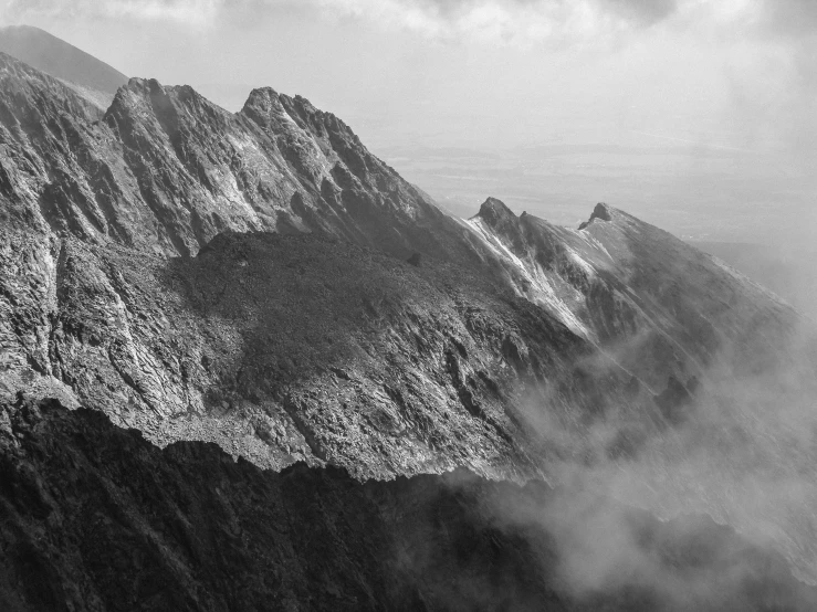 a black and white image of mountains and valleys