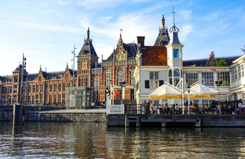 a building by a river and some boats in the water