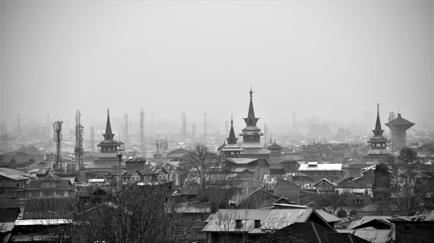 old po of city with spires and roofs in the fog