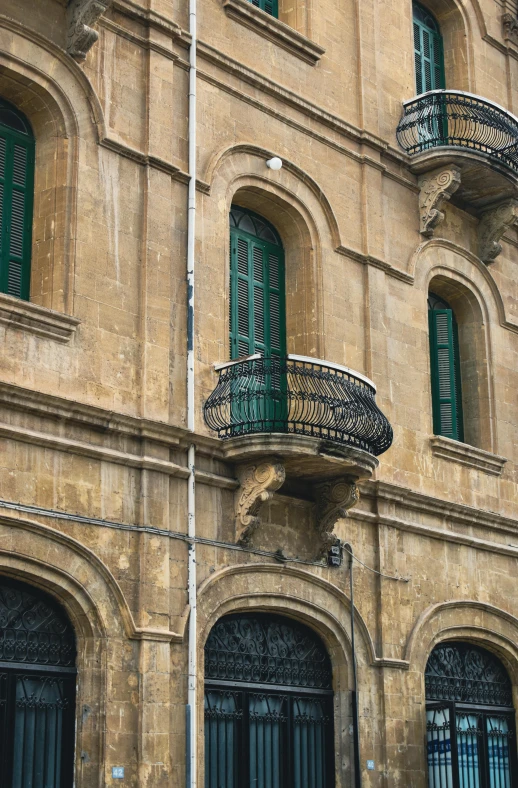 an old house with a balcony and shutters