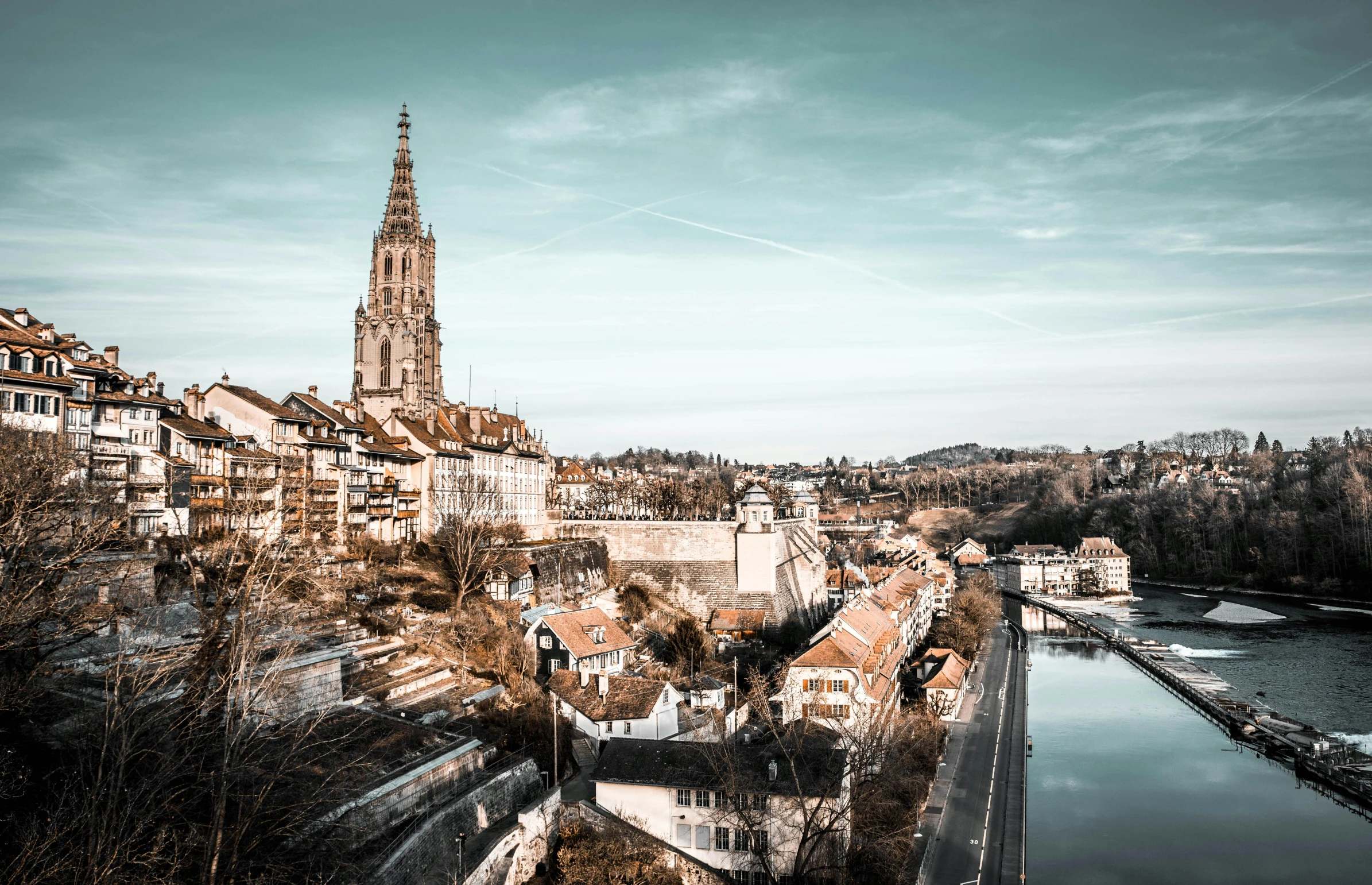 a cityscape next to a river with an ancient looking building