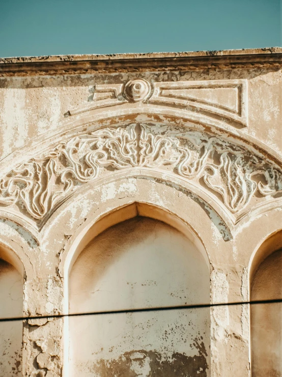 this is an old stone building with a decorative arch above it