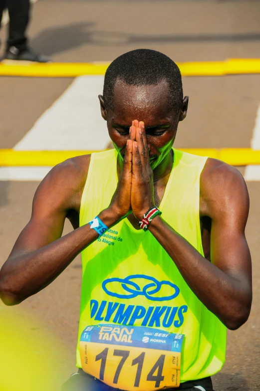 a runner is covering her face while kneeling