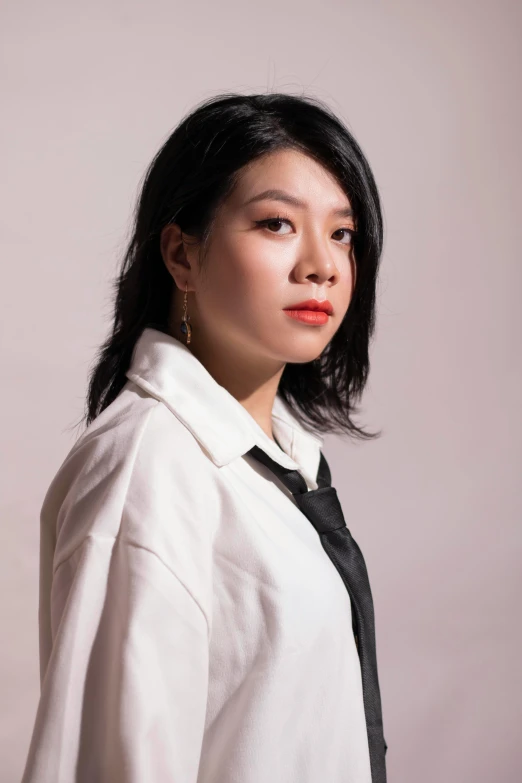 a woman with an asian style shirt and tie