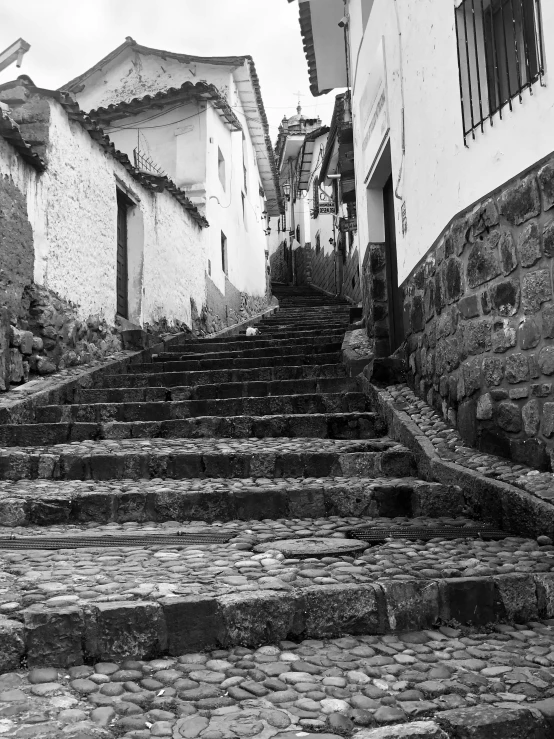 an old stone building has steps in between two buildings