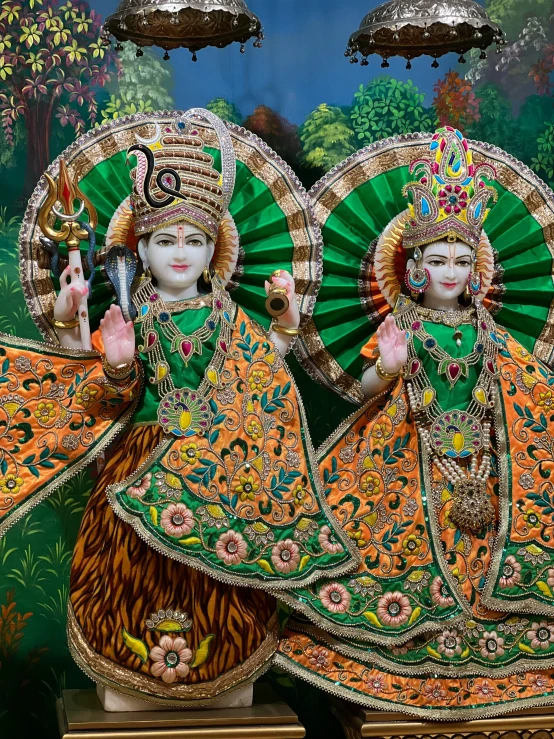 colorfully painted deities in front of wall decorations