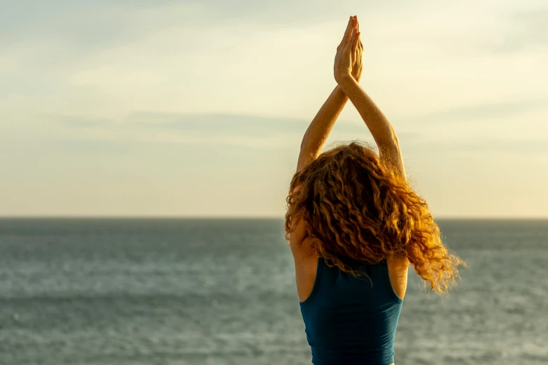 a woman standing in front of a body of water