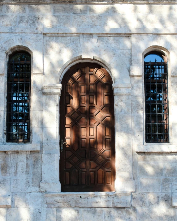 two windows on a building that are in front of a door